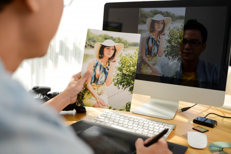 A man holding a portrait of a woman